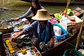 Thailand, Locals sell fruits, food and products at Damnoen Saduak floating market near Bangkok 